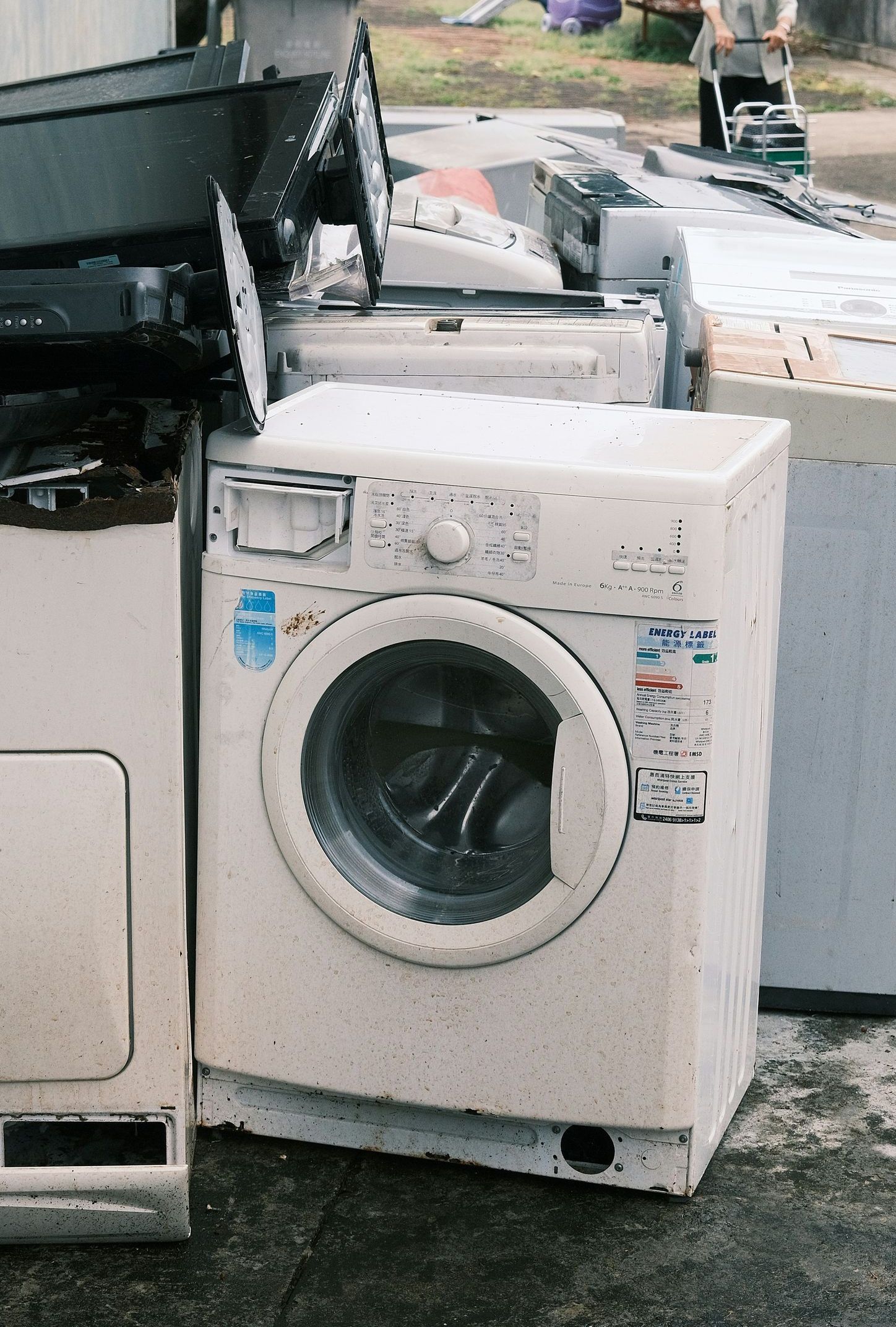a pile of washing machines sitting next to each other